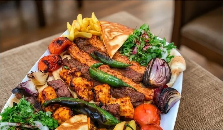 Large Mixed Grill Platter with grilled chicken, beef and lamb skewers, fries, sumac salad, grilled vegetables and pita